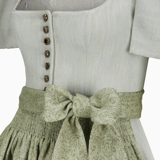 Light gray top with button details and a green textured skirt on a white background